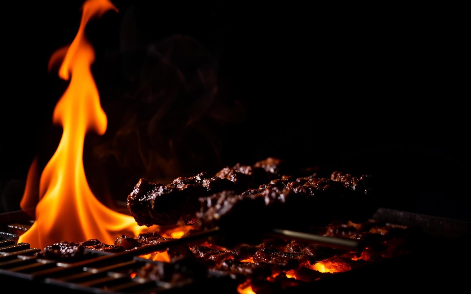 Sizzling BBQ meat over open flames